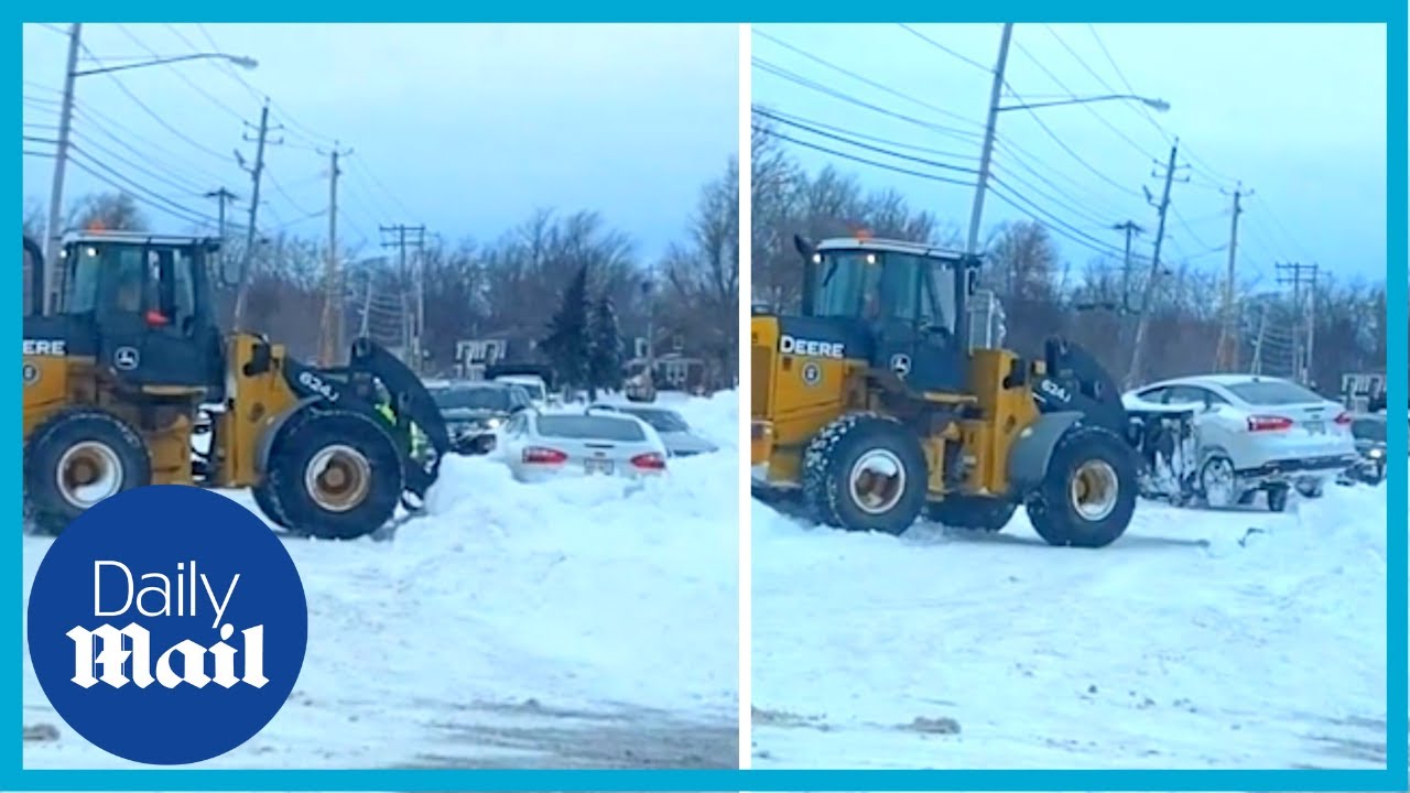New York snow: Wheel loader lifts buried cars out of snowbanks in Buffalo after bomb cyclone