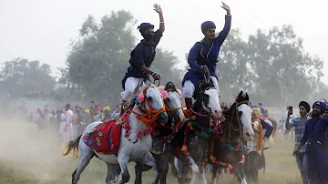 Nihangs demonstrate horse riding skills on Bandi Chhor Divas in Amritsar on Monday