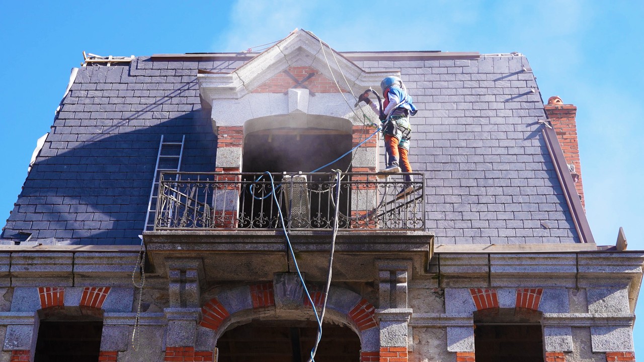 The one where I hang off the chateau sandblasting.