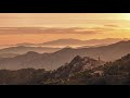 Corsica timelapse  sun rising behind the mountain village of speloncato