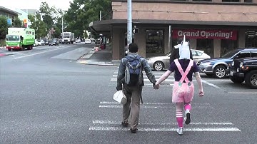 Unicorn helps someone cross the street outside Archie McPhee