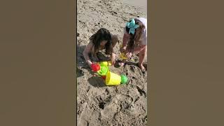 Kids are playing on the beach with sand and having lots of fun. 1st beach day of 2023