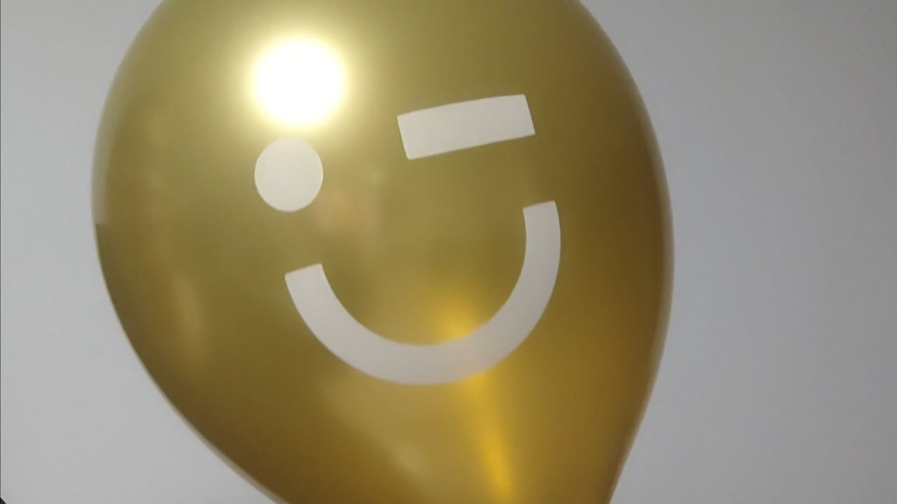 Blow up a gold MINISO advertising balloon