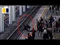 Train officer stops man from jumping onto track