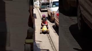 Boy hitches a ride on back of his brothers toy car and flips him backwards