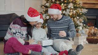 Caring Mother And Father Congratulating Kid On Christmas Giving Gift In Beautiful Box At Home