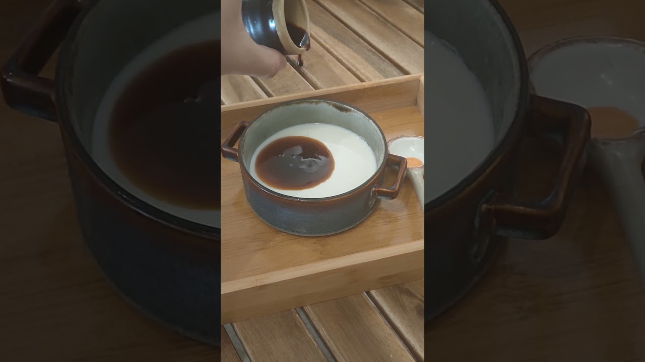 Pouring brown sugar syrup into soy bean pudding 