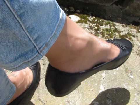 Tamaris black leather flats, nylons and jeans, outdoor shoeplay in the ...