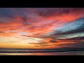 Gorgeous red pastel sunset and ocean waves on a tropical beach