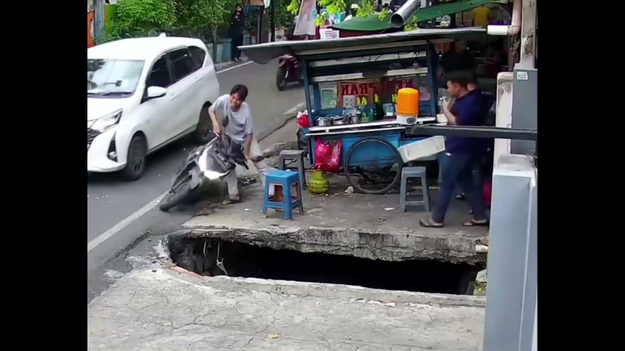 Motorbike falls into water-filled pit in Jakarta, Indonesia