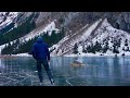 lonely ice skating on a black frozen mountain lake / slow tv nature