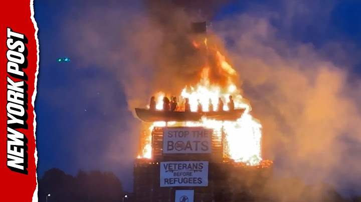 Anti-migrant protesters light up effigy of boat with refugees in Ireland