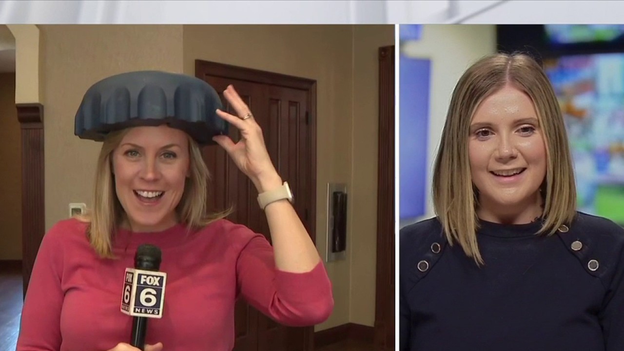 Brewers fan shows off bottle cap hats for NLCS