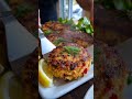 Golden crispy salmon patties with fresh herbs and a squeeze of lemon