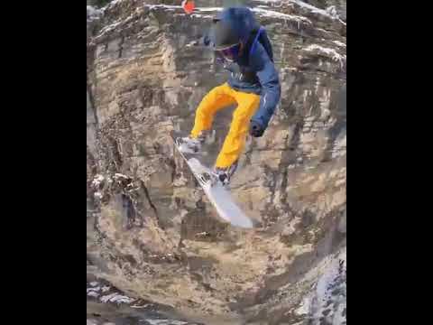 Guy Snowboarding in Mountains Jumps off Cliff and Deploys Parachute - 1113549