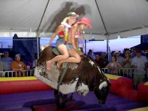 2 girls ride the bull.