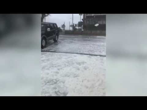 Thick sea foam rolls onto beach during dangerous Cyclone Debbie