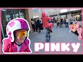 Wheelies around town in a pink suit
