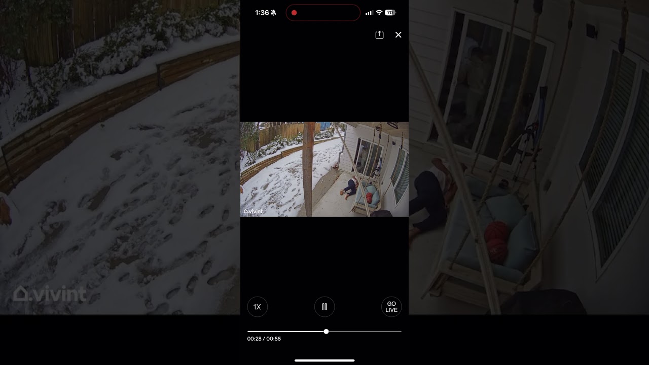 Boy runs on snow then slips near sliding door in backyard Security camera