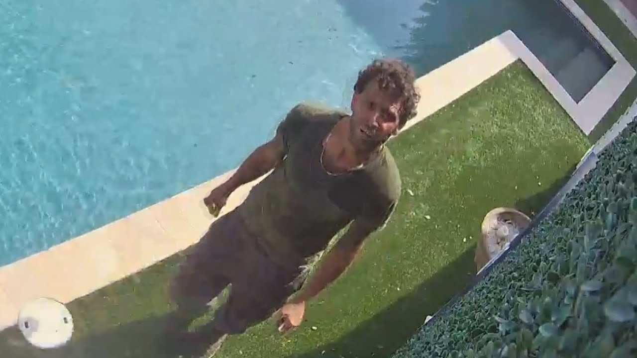 Security video shows man attempting to break into homes while lurking ...