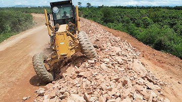 Awesome Works Spreading Mountain Stone For New Province Foundation Roads With A KOMATSU 850 Grader