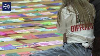 Eisenhower Jr. High students attempt Guinness World Record for longest line of coloring pages