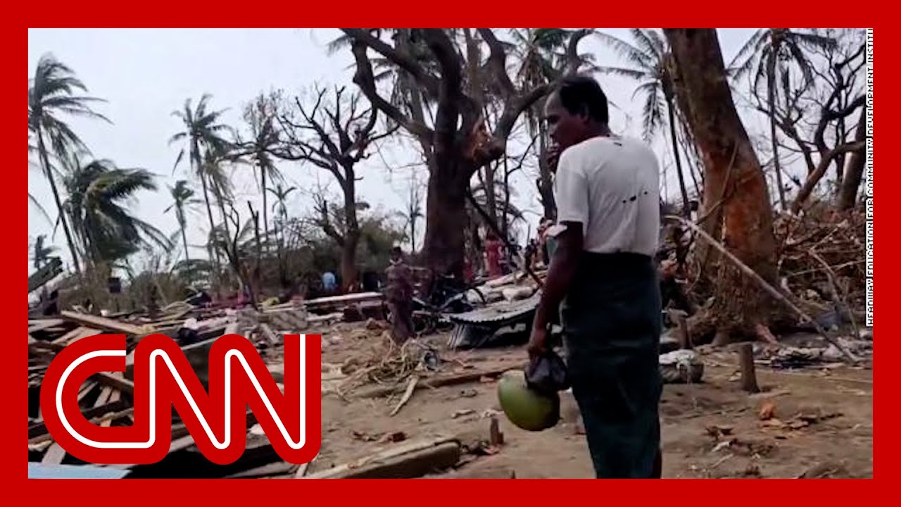 The man wipes away tears as he describes the family swept away by the cyclone
