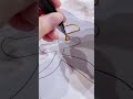 The installation of a wire on top of the motif on the paper is done carefully so that it is neat.