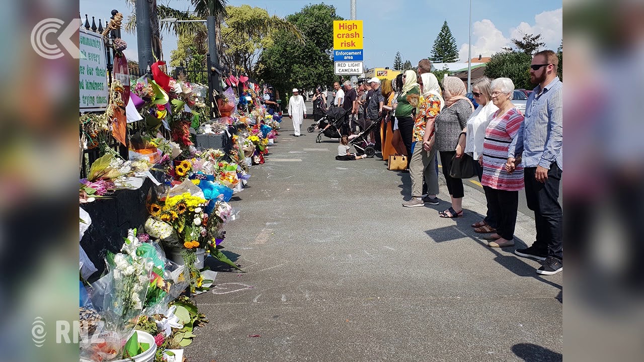 People link arms around NZ mosques during Friday prayers