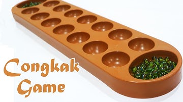Playing Congkak Games - Malaysia Traditional Games