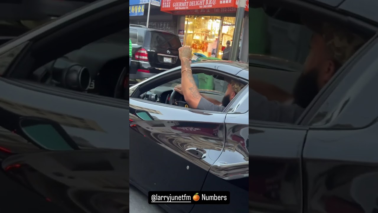 Larry June riding through the city 