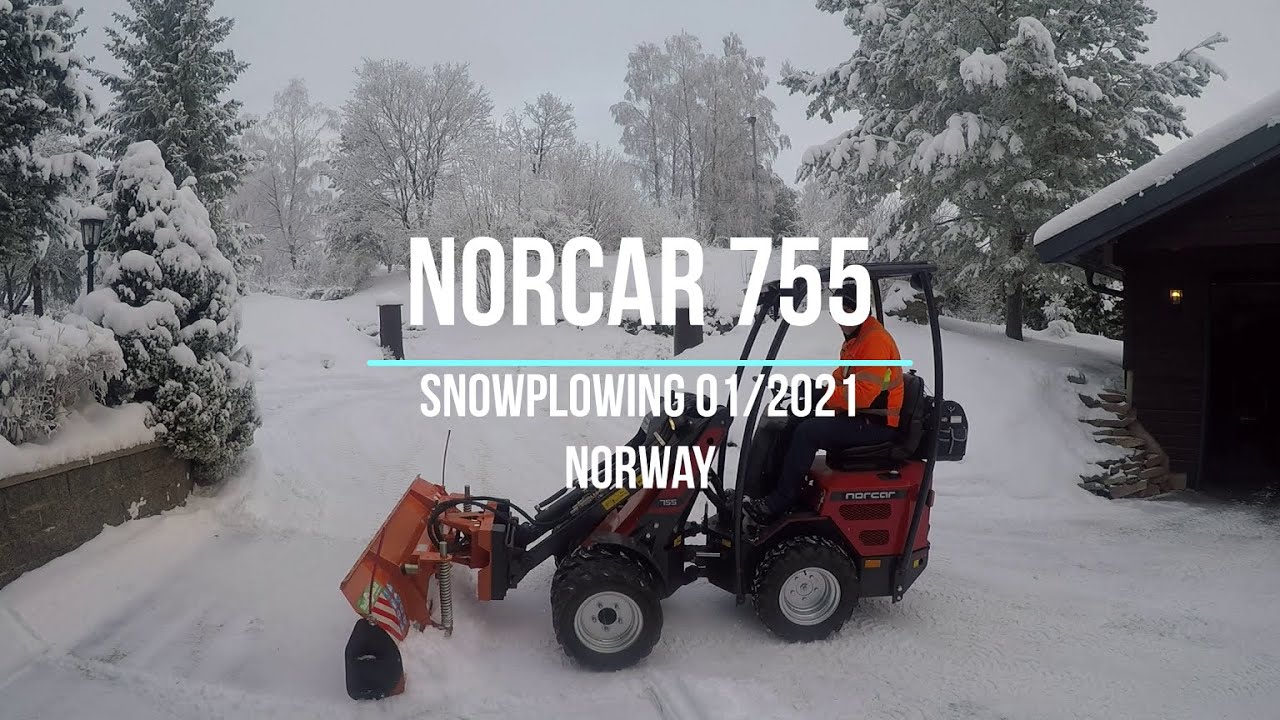 Mini loader Norcar snow plowing daytime, Norway