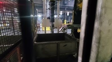 Pickit 3D vision system with a Fanuc robot picking and loading onto a furnace entry conveyor.
