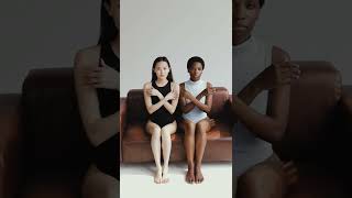 Two Women Sitting On Couch And Crossing Their Arms Short