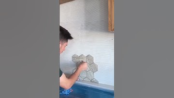 the process of leveling the cement mixture on the wall #shorts