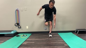 Standing Wall Supported Left Knee Flexion with Resisted Right Glute Max
