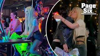 Tori Spelling gives ex Dean McDermott’s girlfriend, Lily Calo, a hug and kiss during arcade outing