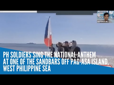 PH soldiers sing the national anthem at one of the sandbars off Pag-asa Island, West Philippine Sea