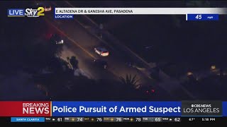 Suspect narrowly avoids oncoming traffic while splitting lanes