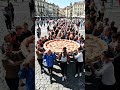 One hundred people are carrying the world's largest pizza.