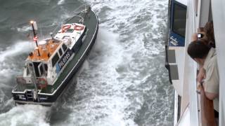 Lisbon pilot disembarking from Adonia in rough seas