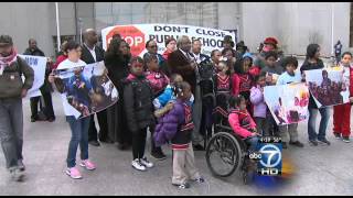 District sued over school closings