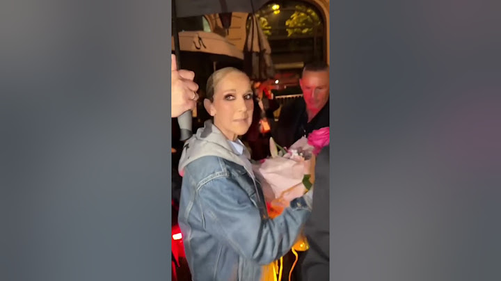 Celine Dion receives rose from a fan after Olympics Opening Ceremony performance