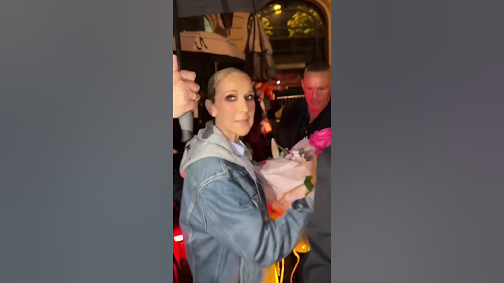 Celine Dion receives rose from a fan after Olympics Opening Ceremony performance
