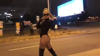 Trans Goddess Kim Petras posing in front of Transphobes