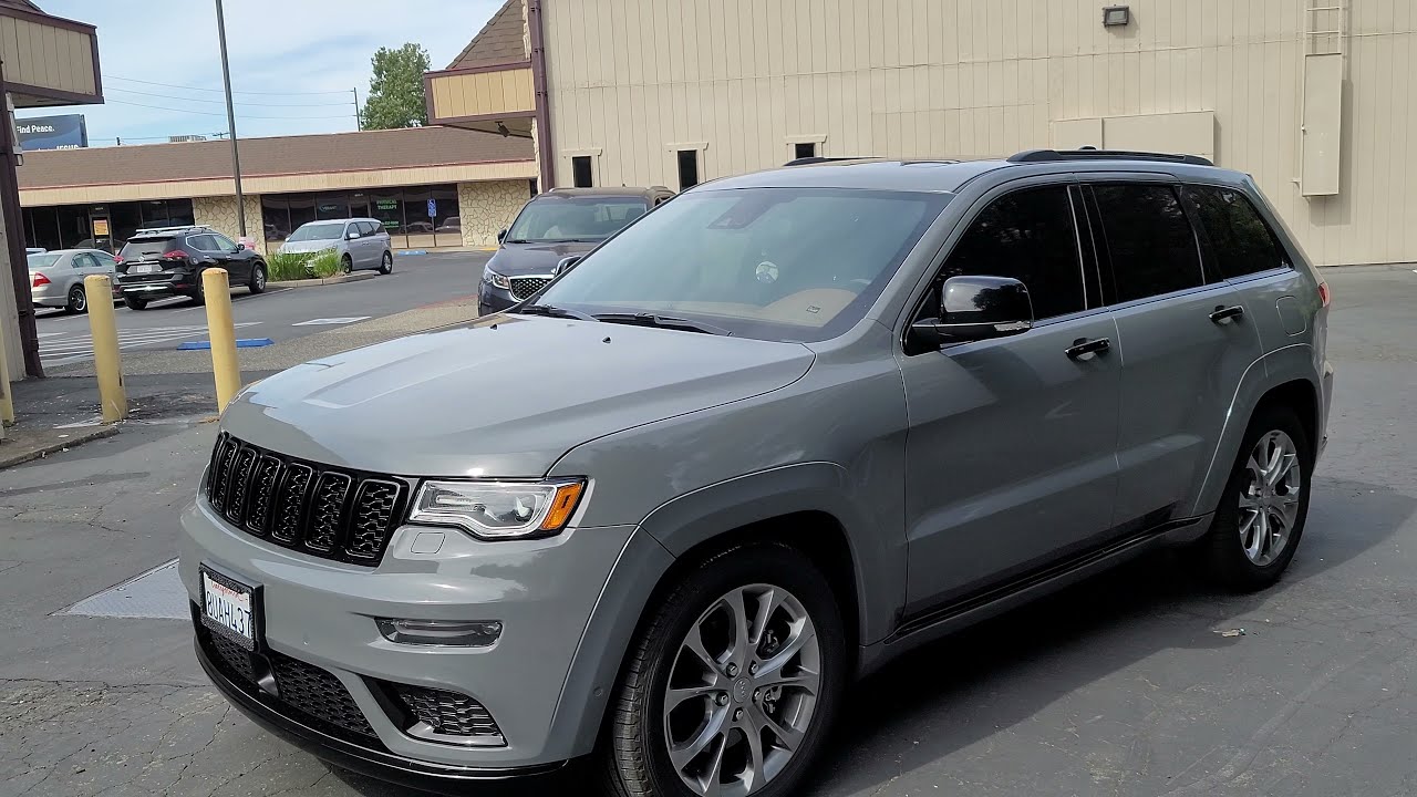 Jeep wrapped in Avery Gloss Rock Grey with full chrome delete.