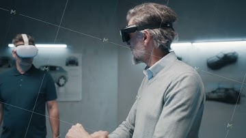 Engineers with vr glasses talk about vehicle production in high tech laboratory