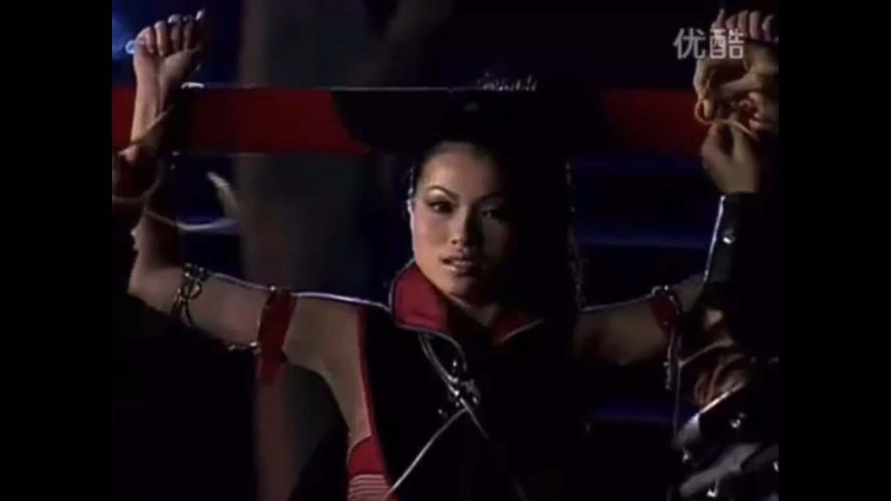 Mai Wynn Tied In Front Of Flaming Arrows