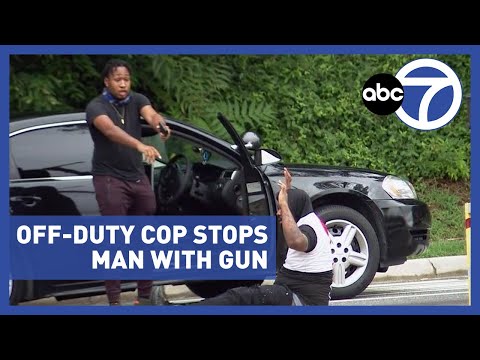 Officer hailed as hero after road rage dispute involving gun