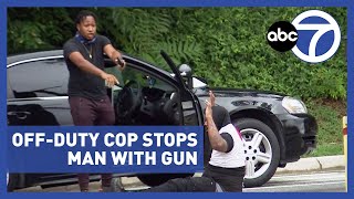 Officer hailed as hero after road rage dispute involving gun